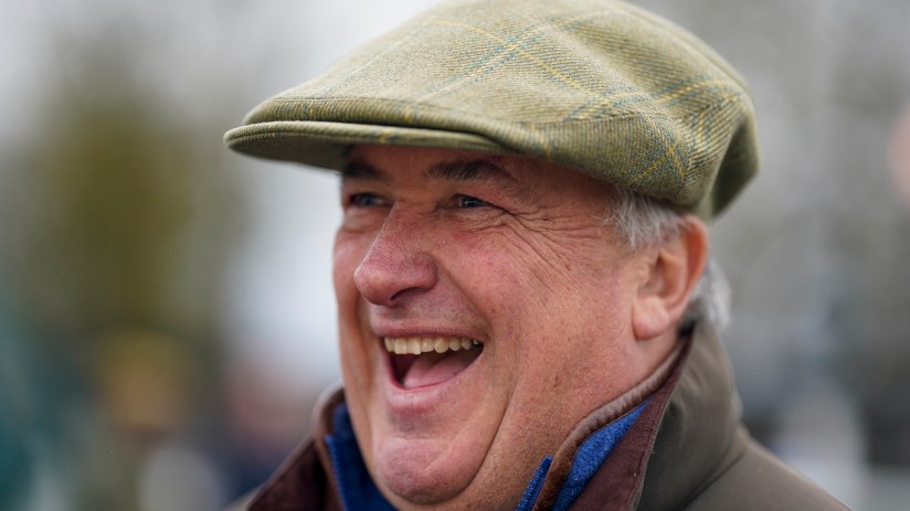 Getty Images logo displayed on a smartphone screen with blurred financial data charts in the background.