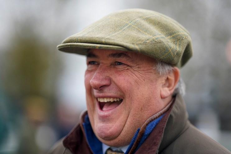 Getty Images logo displayed on a smartphone screen with blurred financial data charts in the background.