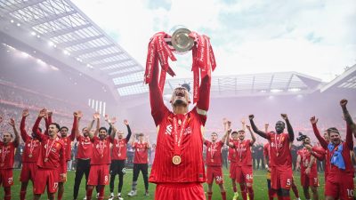 GettyImages 2217027320 captures a dynamic news event with diverse individuals engaged in a lively business discussion.