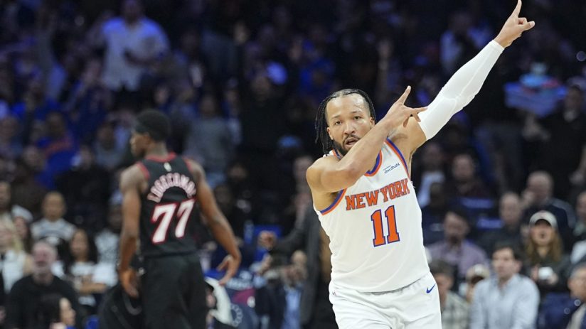 Getty Images logo displayed on a smartphone screen with a blurred stock market chart in the background.