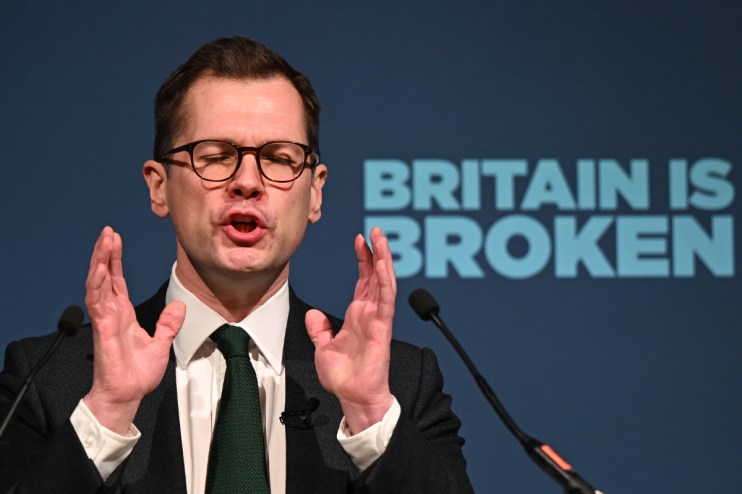 Getty Images logo on a smartphone screen with a blurred cityscape background, symbolizing digital media and photography news.