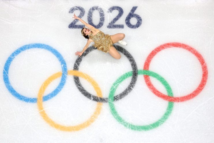 GettyImages 2262533221: Business professionals in a meeting discussing market strategies, diverse team collaboration, corp...