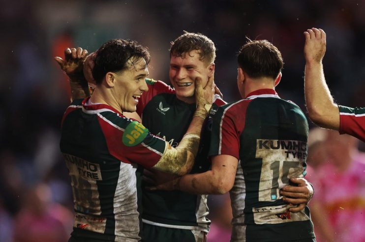GettyImages 2262826394 showing a business conference with diverse professionals engaged in discussion at a round table mee...