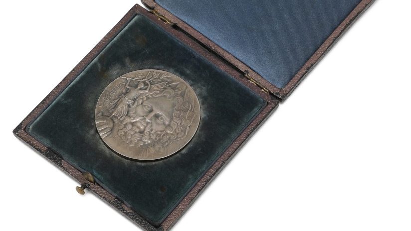 Silver medal from the first Olympic Games in Athens 1896, Greece, displayed in an ornate presentation box.