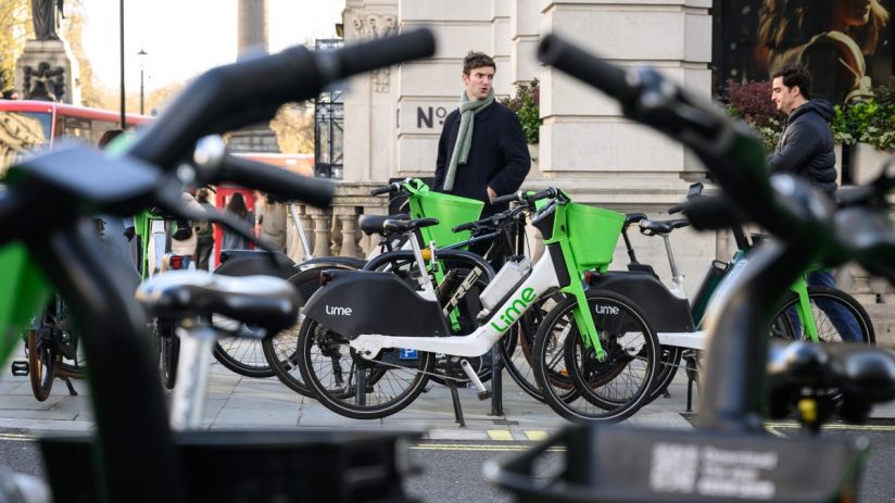 Lime e-bikes lined up in London, showcasing sustainable urban transport solutions in a bustling city environment