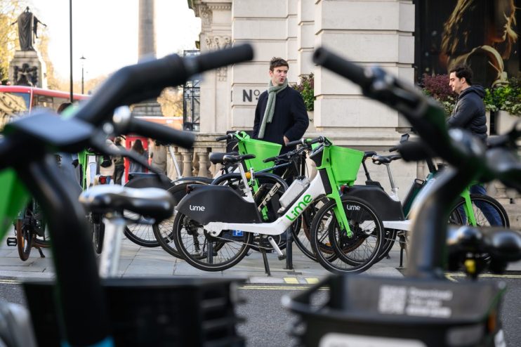 Lime e-bikes lined up in London, showcasing sustainable urban transport solutions in a bustling city environment