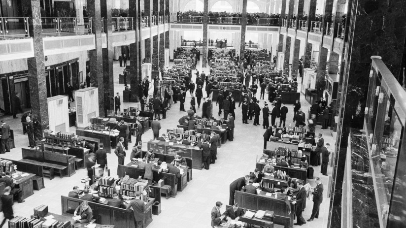 Modern London office interior with open-plan workspace, sleek desks, ergonomic chairs, and large windows offering city views.