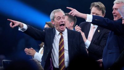 Nigel Farage speaking at Reform UK rally in Birmingham, February 2026, addressing supporters in a crowded venue