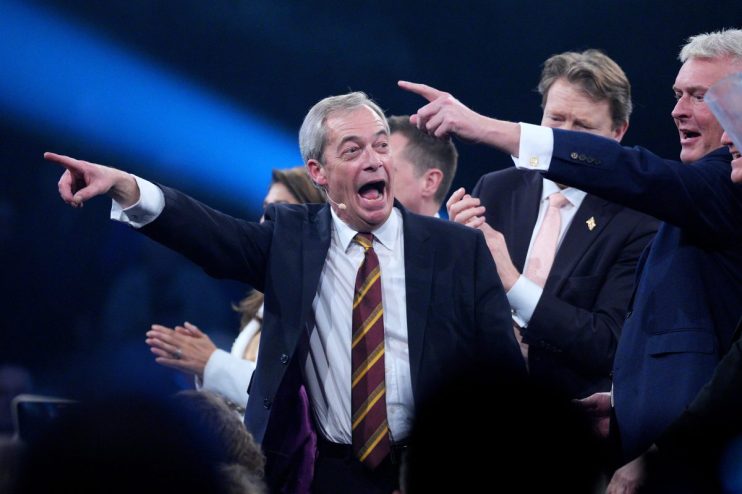 Nigel Farage speaking at Reform UK rally in Birmingham, February 2026, addressing supporters in a crowded venue
