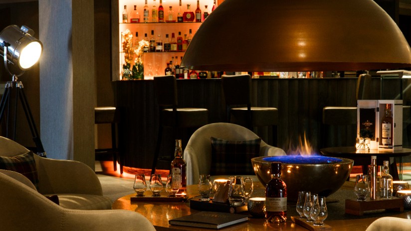 Cozy living room with a modern fireplace at The Snug, featuring elegant decor and warm ambient lighting.