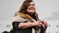 Anne Boden speaking at a business conference, highlighting financial innovations and industry leadership.