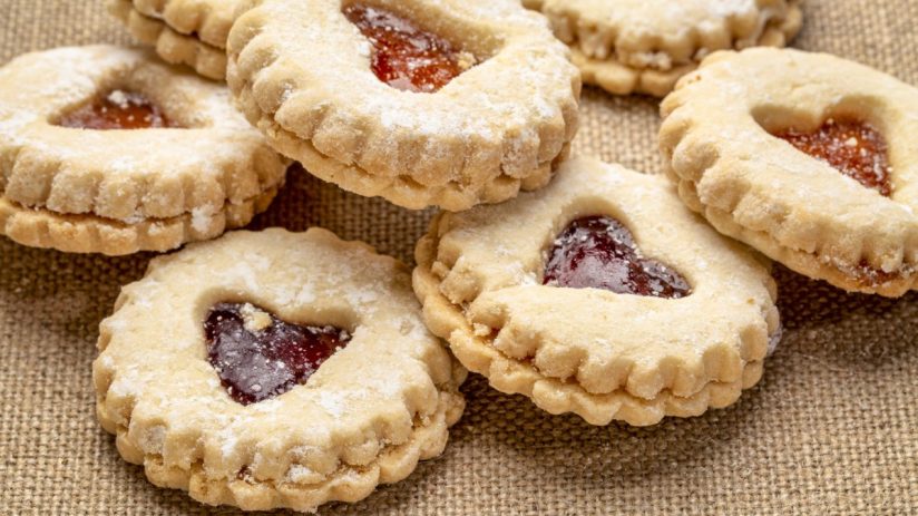Freshly baked golden biscuits on a baking tray, showcasing a variety of shapes and textures, ideal for a breakfast feature
