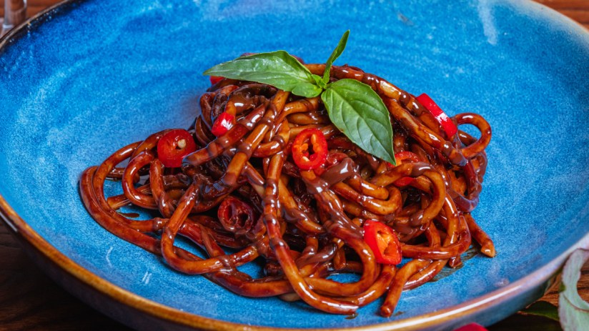 Chocolate spaghetti dish creatively presented on a plate, showcasing a unique culinary fusion for a gourmet dining experie...