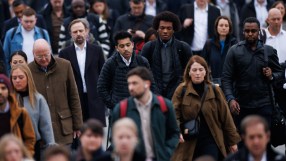 London commuters navigating busy streets during rush hour, showcasing urban lifestyle and public transportation dynamics.