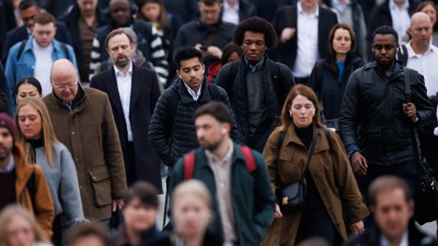 London commuters navigating busy streets during rush hour, showcasing urban lifestyle and public transportation dynamics.