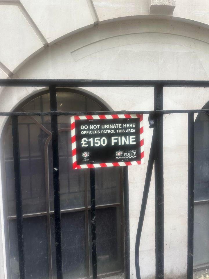 Sign displaying Do Not Urinate warning on a public wall, emphasizing cleanliness and public hygiene enforcement.