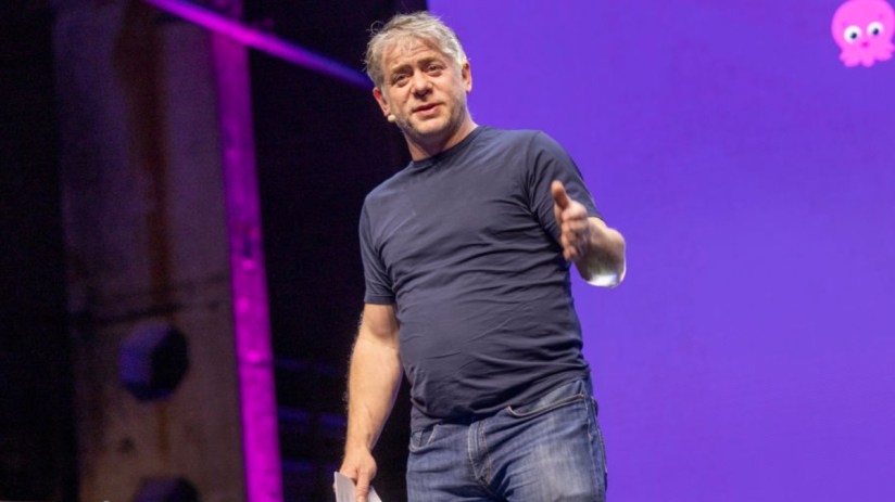 Greg Jackson, CEO of Octopus Energy, stands confidently in office attire, symbolizing his decision not to join Pisces proj...
