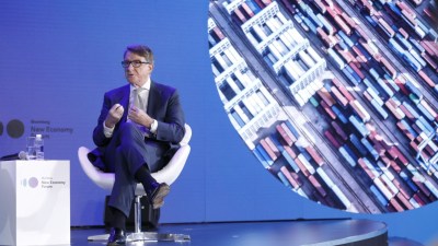 Peter Mandelson, founder of Global Counsel, delivering a speech, wearing a suit and gesturing at a business conference.