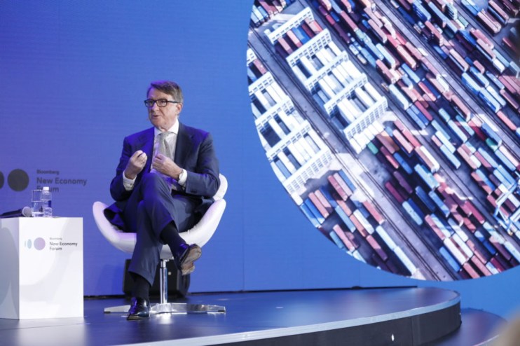 Peter Mandelson, founder of Global Counsel, delivering a speech, wearing a suit and gesturing at a business conference.