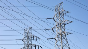 Pylons standing tall against a clear sky following Engies acquisition of UK Power Networks, symbolizing energy sector growth.