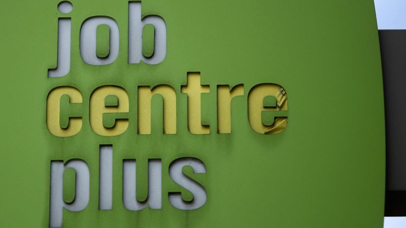 Business executives discussing corporate restructuring amid job cuts in modern office setting, reflecting economic challenges