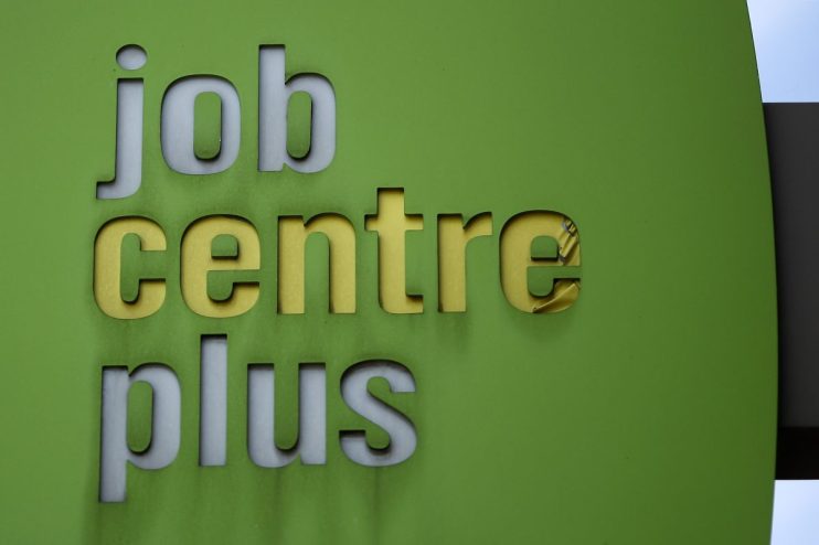 Business executives discussing corporate restructuring amid job cuts in modern office setting, reflecting economic challenges