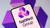 NatWest bank logo prominently displayed on a modern glass building, reflecting the financial institutions corporate identity.