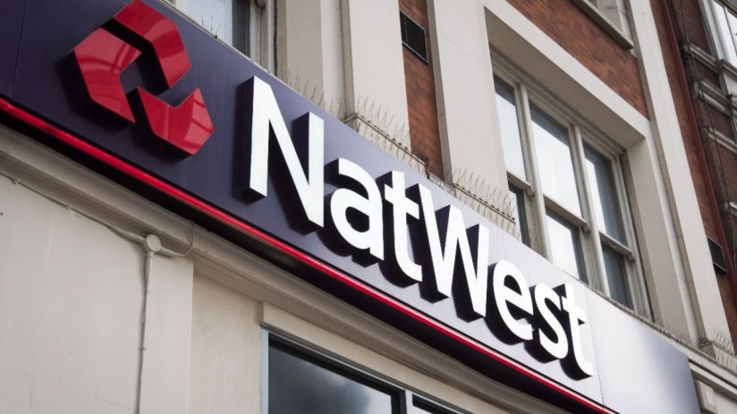 NatWest bank front entrance with logo and signage on urban street, highlighting financial institution presence in the city.