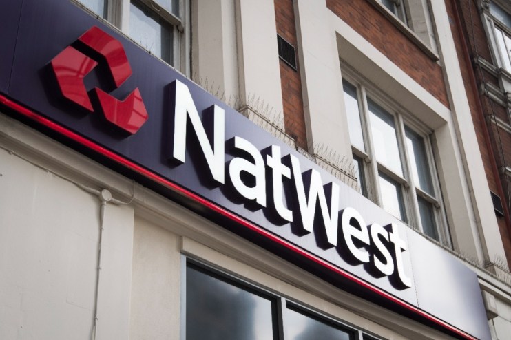 NatWest bank front entrance with logo and signage on urban street, highlighting financial institution presence in the city.