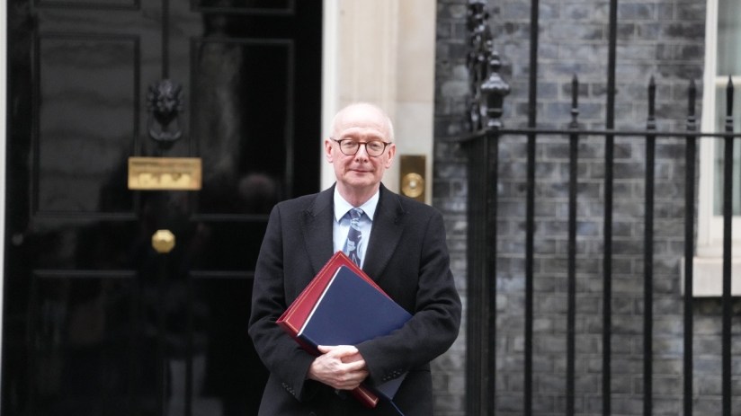 Pat McFadden speaking at a podium during a press conference, addressing current general news topics.