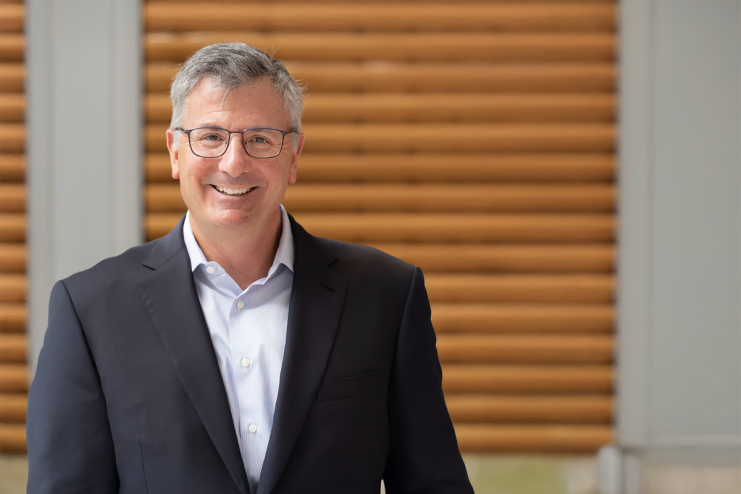 Erik Hirsch, private credit executive, discussing financial strategies at a business conference podium with a focused audi...