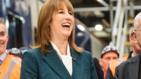 Rachel Reeves appointed as Chancellor, smiling confidently at podium during press conference, emphasizing economic policy.