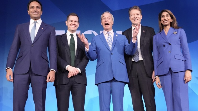 Shadow Cabinet members discussing reform strategies at a conference table with documents and laptops in a modern office se...