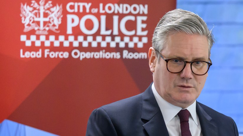 Keir Starmer engaging with City of London Police officers in a formal meeting setting, discussing urban safety initiatives.