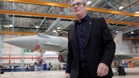 Keir Starmer discussing UKs defense strategy with BAE Systems executives in a formal meeting setting