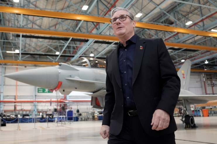 Keir Starmer discussing UKs defense strategy with BAE Systems executives in a formal meeting setting