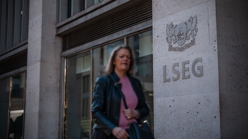 London Stock Exchange building exterior with financial charts overlay, highlighting impact of stamp duty on share listings.
