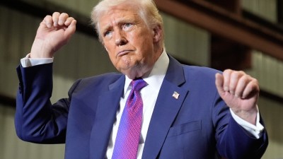 Donald Trump dancing at a campaign rally in Pennsylvania, engaging supporters with enthusiastic gestures and lively expres...
