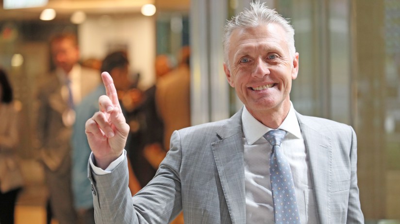 A professional meeting discussing recent business developments with diverse executives around a conference table