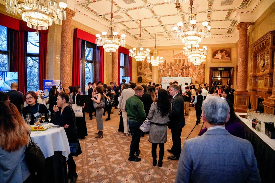 Guests engage in networking at a business event, showcasing professional interaction and collaboration.