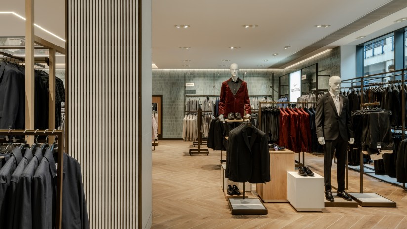 Breaking news update on major business merger showcasing executives shaking hands in a corporate boardroom setting