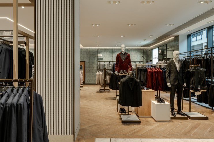 Breaking news update on major business merger showcasing executives shaking hands in a corporate boardroom setting