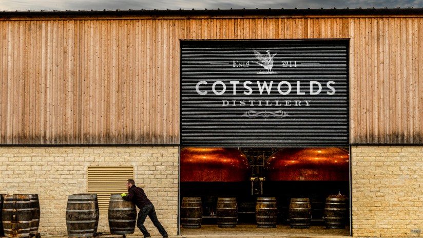 Cotswolds distillery exterior showcasing modern architecture in 2023, nestled in picturesque countryside setting
