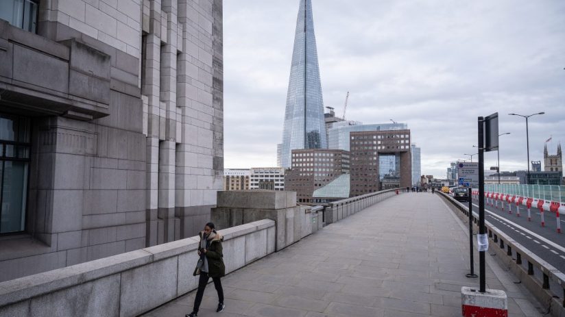 London Bridge eerily empty during Covid lockdown with overcast skies and historic architecture visible in the background.
