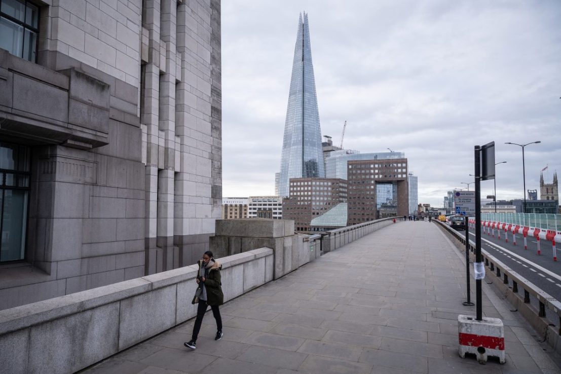 LONDON, ENGLAND - MARCH 30: A woman crosses London Bridge during what would usually be the busy pre-9am rush-hour on March 30, 2020 in London, England. The Coronavirus (COVID-19) pandemic has spread to many countries across the world, claiming over 30,000 lives and infecting hundreds of thousands more. (Photo by Leon Neal/Getty Images)