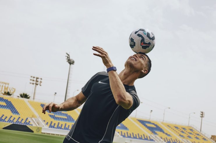 Cristiano Ronaldo celebrating a goal on the soccer field, showcasing his iconic jersey and jubilant expression during a ma...