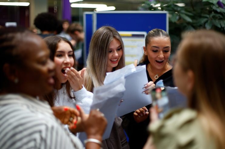 Students joyfully celebrate after receiving exam results, showcasing diverse emotions and camaraderie on campus.
