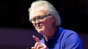 Breaking news event with crowd gathered, capturing diverse reactions and cityscape backdrop, emphasizing current global is...