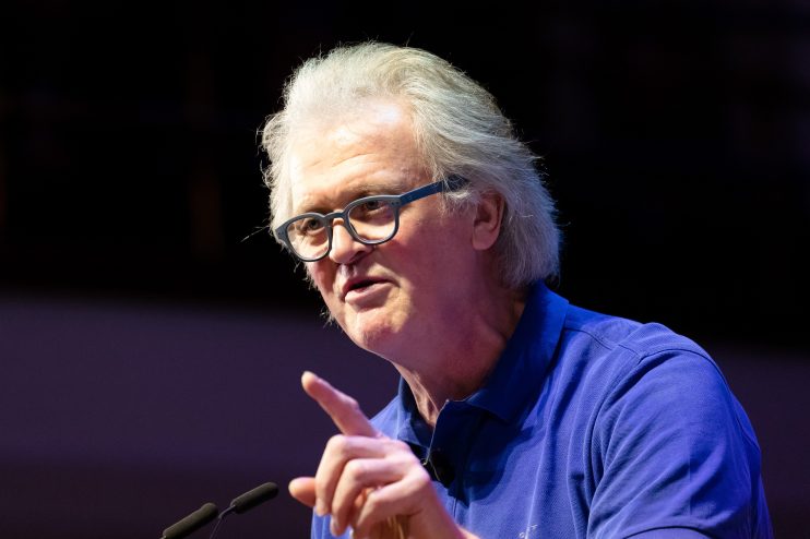 Breaking news event with crowd gathered, capturing diverse reactions and cityscape backdrop, emphasizing current global is...