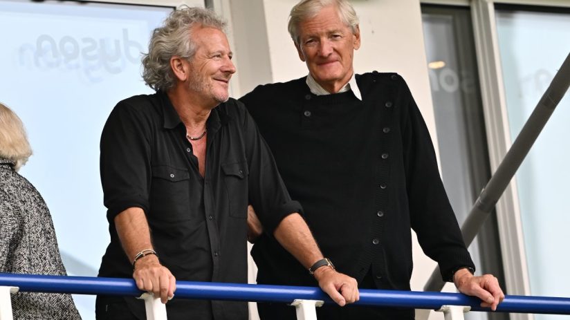 Business professionals discussing financial trends in a modern office setting, emphasizing collaboration and data analysis